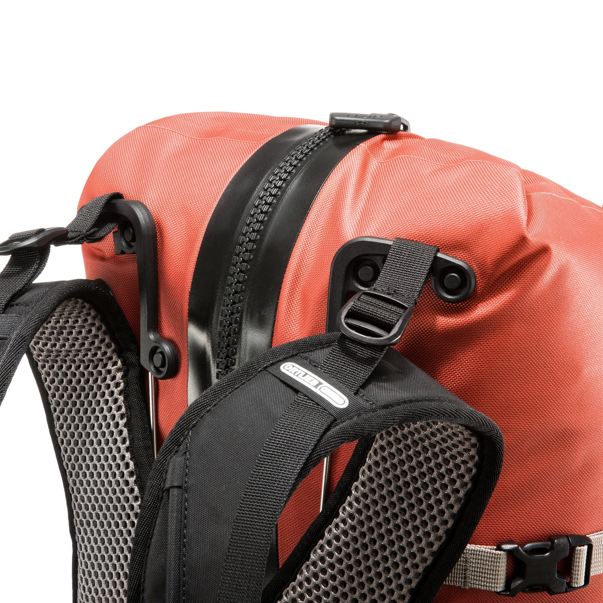 Detail view of the waterproof ORTLIEB Atrack outdoor backpack in rooibos color with 25 liters volume, featuring padded shoulder straps, sturdy attachment loops, and a reinforced back panel.