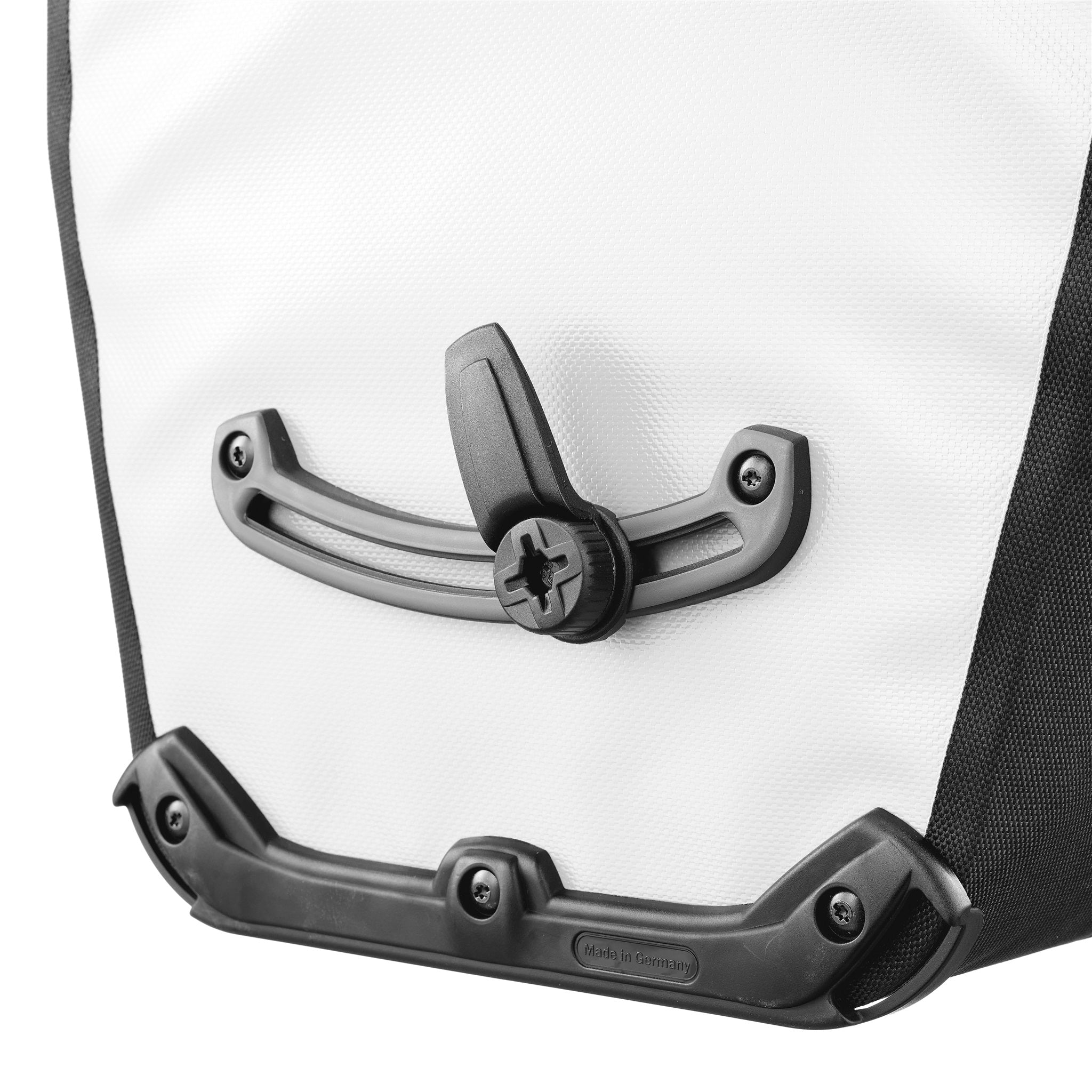 Woman wearing bike helmet carries ORTLIEB Back-Roller Design bag in design "Morning Routine" up stairs