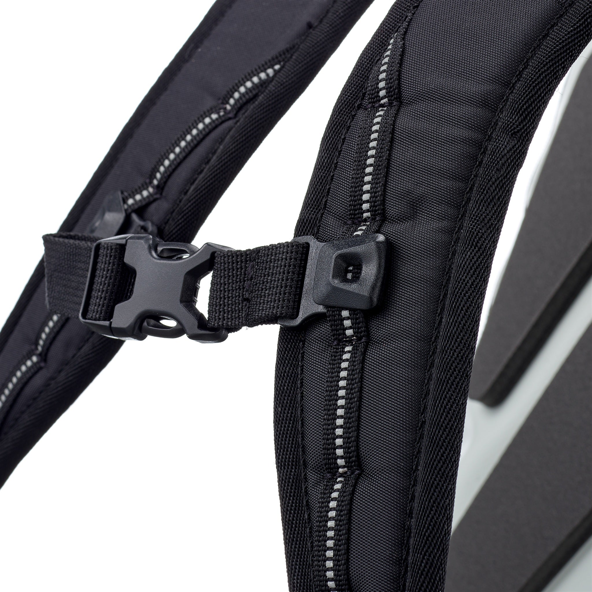 Close-up of chest strap buckle with reflective tape on ORTLIEB Velocity Design backpack